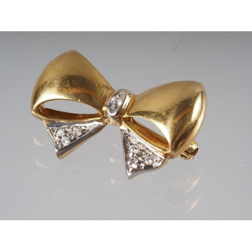 342 - An 18ct gold 'bow' brooch set diamonds, 10ct approx, 5.3g gross