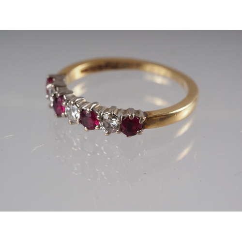 344 - An 18ct gold half-eternity hoop set rubies, .52ct approx, and diamonds .26ct approx, size M/N