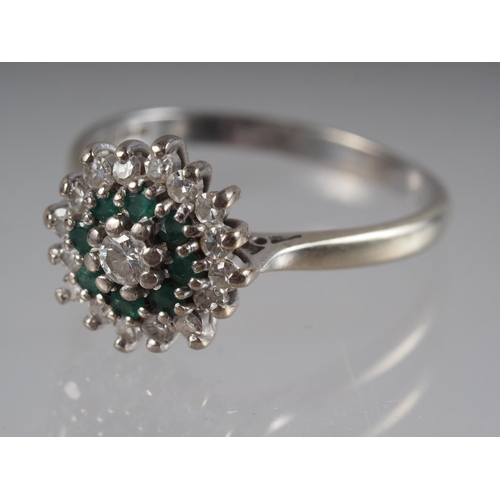 359 - An 18ct white gold dress ring cluster set emeralds and diamonds, 4.4g gross, size R