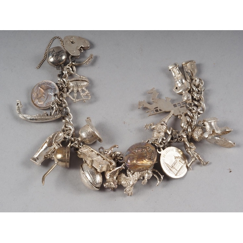 362 - A silver charm bracelet with twenty-one charms approx, 3.4oz troy approx