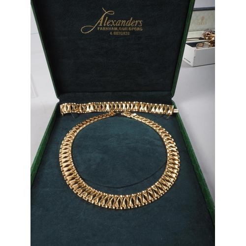 374 - An 18ct gold 'X' link necklace and a matching bracelet, 116g, in fitted case