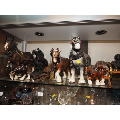 43 - Five ceramic model horses with accessories, including tack and carriages, and a cold cast eventing h... 