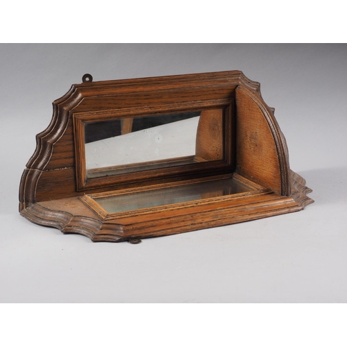 580 - An oak corner wall bracket with shaped top and mirrored back, 19 3/4