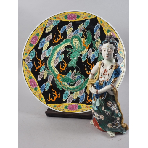 81 - A Japanese polychrome charger with dragon, cloud and flower decoration, 18 3/4