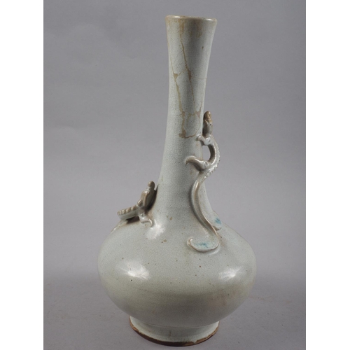 82 - A Chinese bottle necked vase with pale glaze and relief dragon decoration, 13