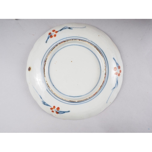 85 - A pair of Japanese Imari plates and a similar plate with bird centre, 8 1/2