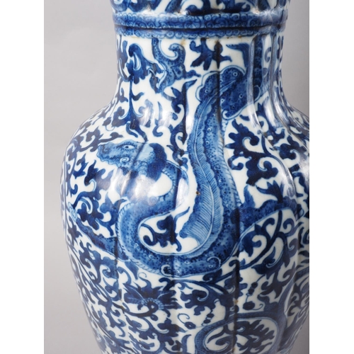 93 - A Chinese blue and white baluster vase with reeded sides, dragon and scroll decoration and seal mark... 