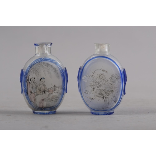 105 - Two Chinese blue and clear glass snuff bottles, 2 1/2