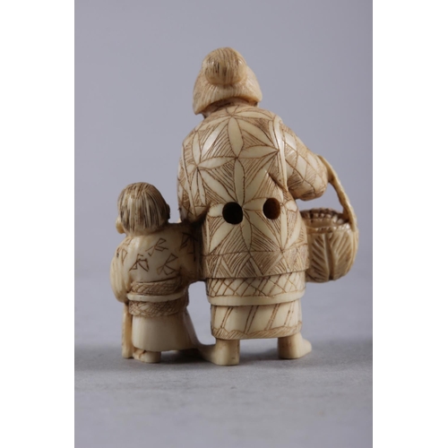 121 - An early 20th century carved ivory figure group/netsuke woman and child, 2