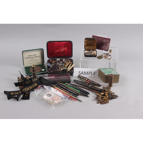 215 - An assortment of fountain pens, badges, pipes, playing cards, cigarette cards and other items