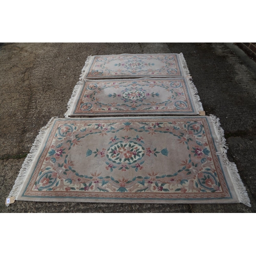 665 - A Chinese contour pile rug with floral design on a grey ground, 70