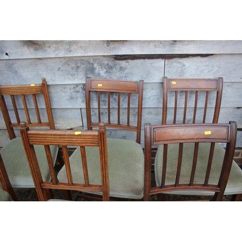 572 - A matched set of six vertical rail back dining chairs with stuffed over seats, on square taper suppo... 