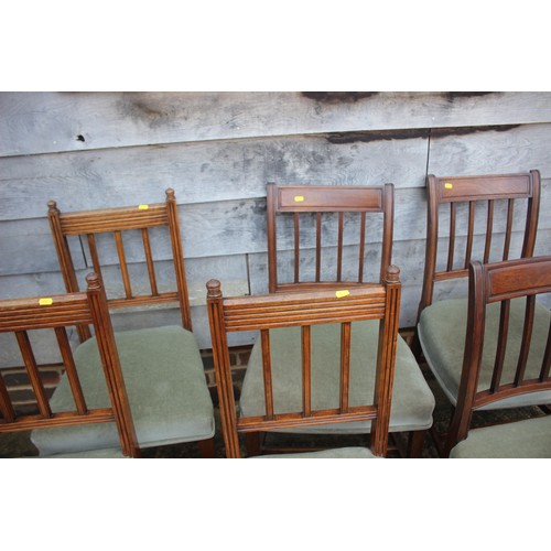 572 - A matched set of six vertical rail back dining chairs with stuffed over seats, on square taper suppo... 