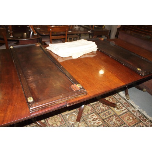 526 - A 19th century mahogany triple pedestal dining table with two extra leaves, on turned columns and qu... 