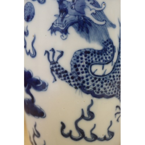 90 - A pair of Chinese elongated drum shaped vases with dragon and cloud decoration, 10 1/4