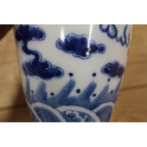 90 - A pair of Chinese elongated drum shaped vases with dragon and cloud decoration, 10 1/4