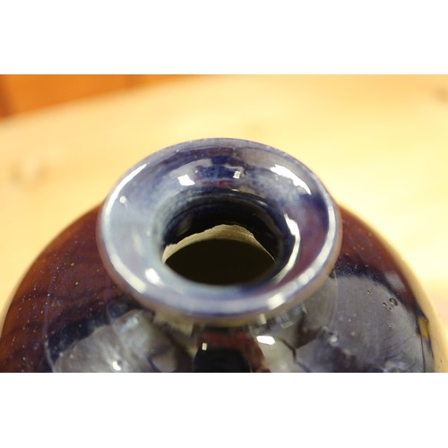 88 - A Chinese monochrome sang de boeuf glazed sprinkler bottle, on hardwood stand, 6 1/4