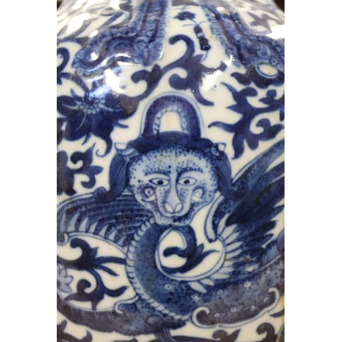 93 - A Chinese blue and white baluster vase with reeded sides, dragon and scroll decoration and seal mark... 