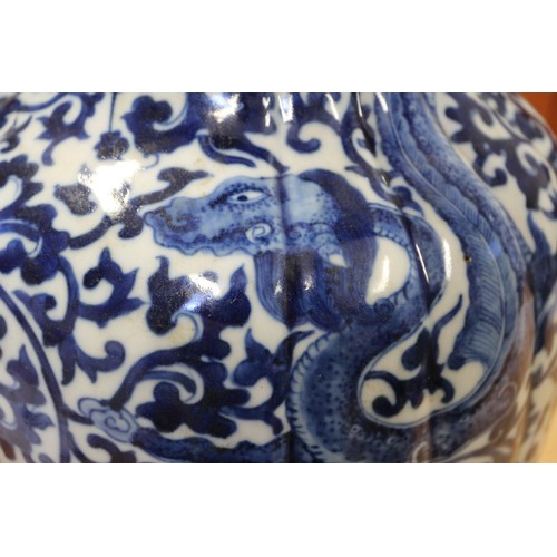 93 - A Chinese blue and white baluster vase with reeded sides, dragon and scroll decoration and seal mark... 