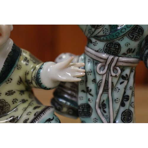 110 - A Chinese porcelain famille verte enamel decorated figure group, 5 1/4