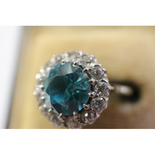 380 - A platinum dress ring set blue zircon and collar of diamonds, size N, 4.3g gross