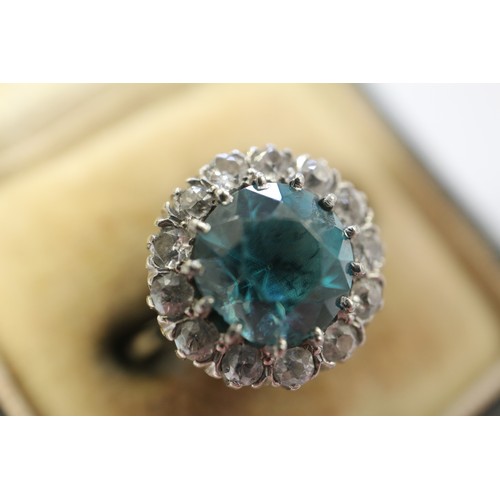 380 - A platinum dress ring set blue zircon and collar of diamonds, size N, 4.3g gross