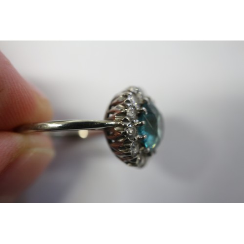 380 - A platinum dress ring set blue zircon and collar of diamonds, size N, 4.3g gross