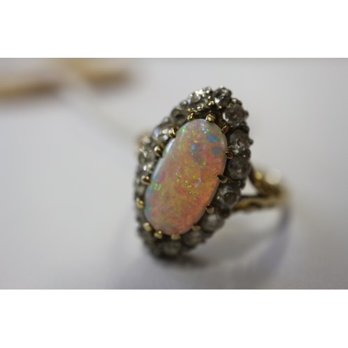 337 - An 18ct yellow gold dress ring, set oval opal with collar of diamonds, opal 13mm x 6mm approx, size ... 