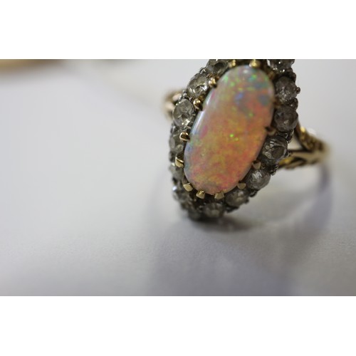 337 - An 18ct yellow gold dress ring, set oval opal with collar of diamonds, opal 13mm x 6mm approx, size ... 