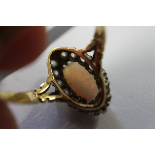 337 - An 18ct yellow gold dress ring, set oval opal with collar of diamonds, opal 13mm x 6mm approx, size ... 