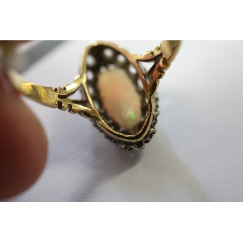 337 - An 18ct yellow gold dress ring, set oval opal with collar of diamonds, opal 13mm x 6mm approx, size ... 