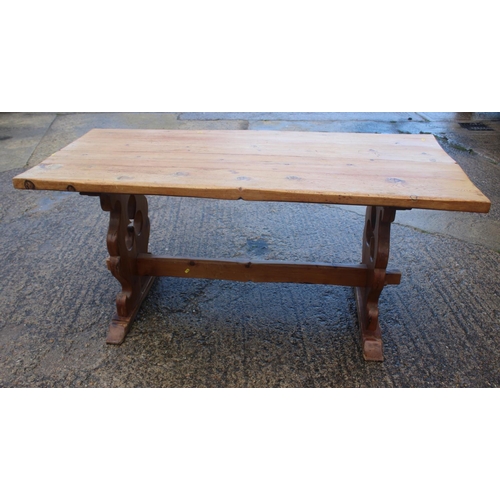 742 - A pine plank top refectory type table, on pierced panel end supports, top 66