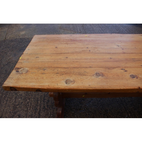 742 - A pine plank top refectory type table, on pierced panel end supports, top 66