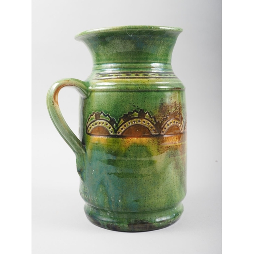 16 - A Ubeda sgraffito and slip decorated jug, 9 1/2