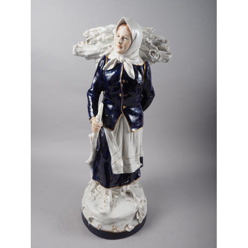 17 - A Royal Dux porcelain figure of a wood gatherer, 12 1/2