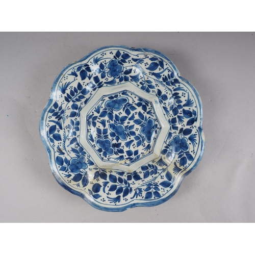 20 - An 18th century majolica lobed dish with floral decoration, 10 1/4