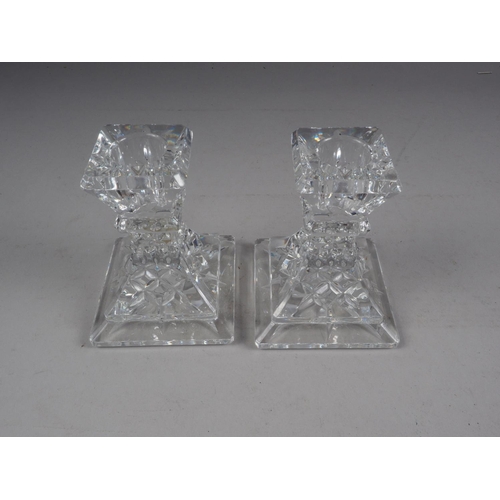 54 - A pair of Waterford squat candlesticks, on square bases, 4