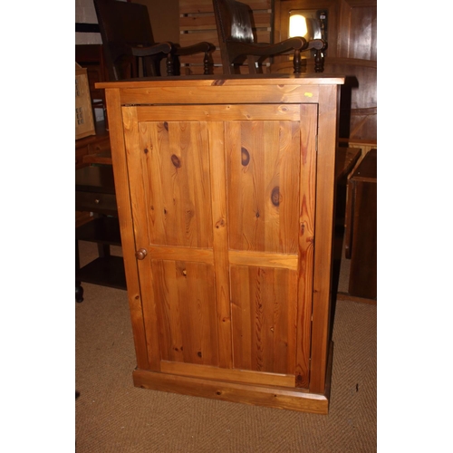 740 - A waxed pine cupboard, fitted adjustable shelves enclosed panelled door, on block base, 33