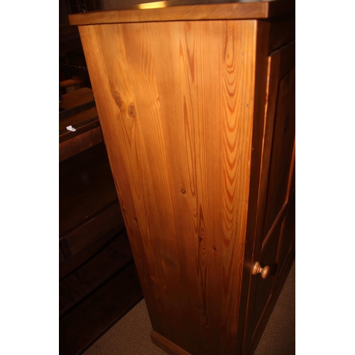 740 - A waxed pine cupboard, fitted adjustable shelves enclosed panelled door, on block base, 33