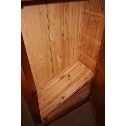 740 - A waxed pine cupboard, fitted adjustable shelves enclosed panelled door, on block base, 33