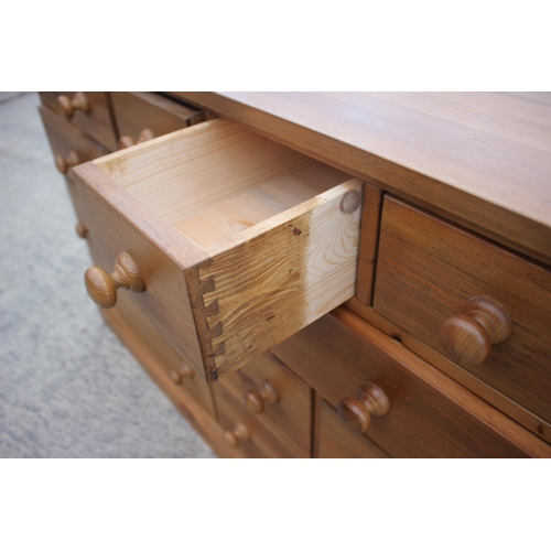 741 - A waxed pine chest of four small drawers, three short drawers over three further short drawers and t... 