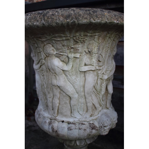 753 - A pair of cast stone urns with classical decoration, on square bases, 42