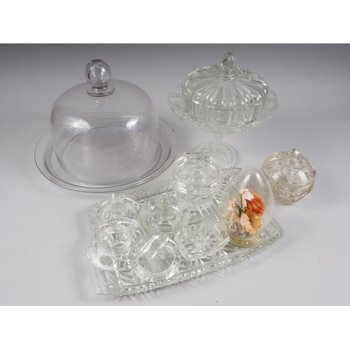 83 - An assortment of glassware, including a glass platter with domed top, a glass tray and other items