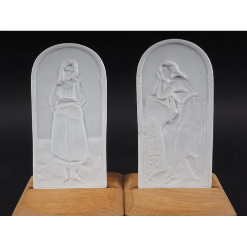 9 - A pair of late 19th century arch top lithophane panels, decorated women, stamped 