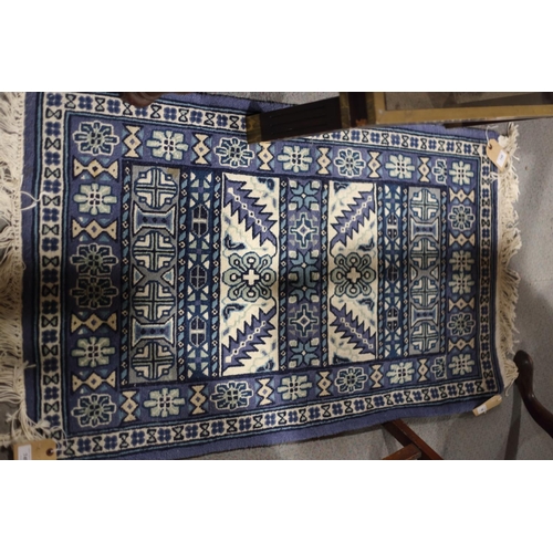 749 - A pair of Tunisian blue garden pattern rugs, 39