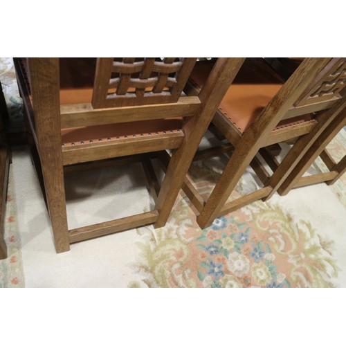 739 - A set of eight Mouseman Thompson oak lattice back standard dining chairs with leather seats, on face... 