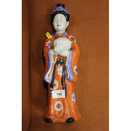 89 - A pair of Chinese porcelain figures of women in orange robes holding jars, 14