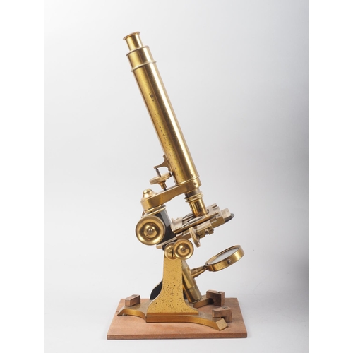 118 - A 19th century brass monocular microscope with two lenses, in fitted mahogany case, 15 1/2