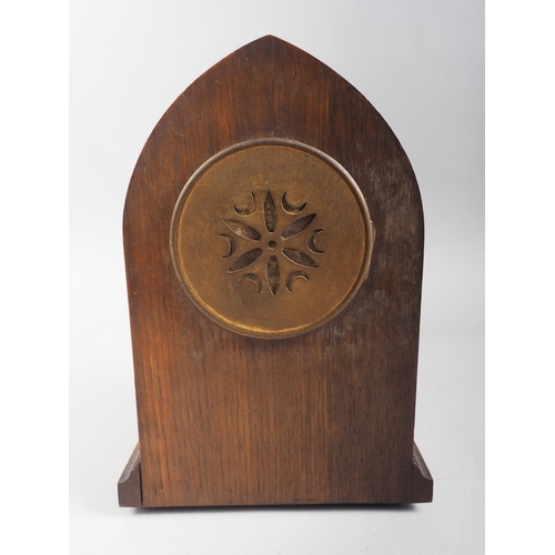 124 - An early 20th century oak arch top mantel clock with line inlay and eight-day striking movement with... 