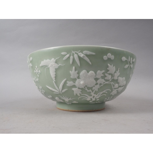 100 - A Chinese porcelain celadon glazed bowl, decorated in high relief with flowers and butterflies, 10 1... 